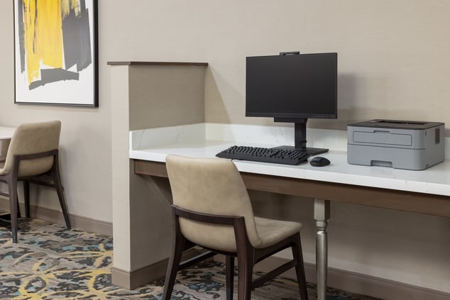 Hotel business center with computer, printer.