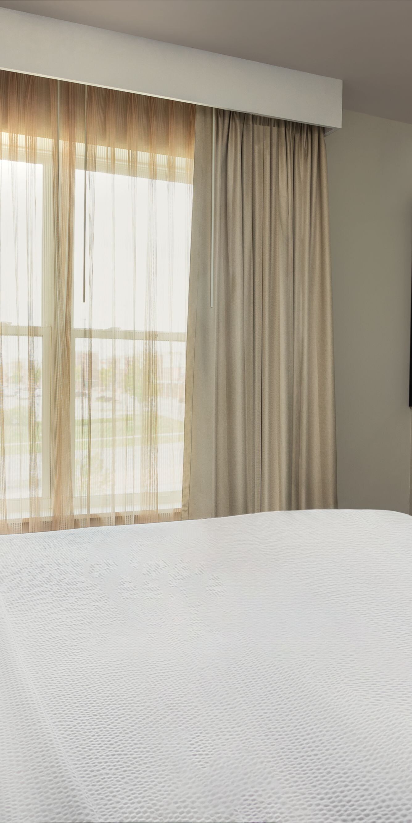 A cozy queen bed with plush bedding