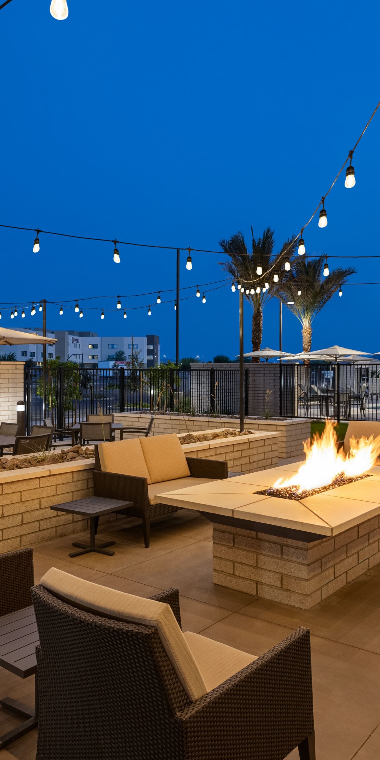 Patio with string lighting over fire pit
