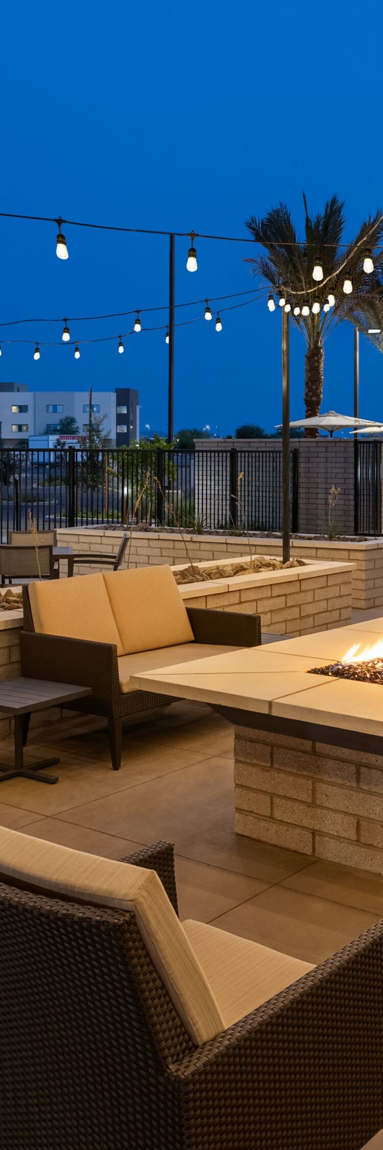 Patio with string lighting over fire pit