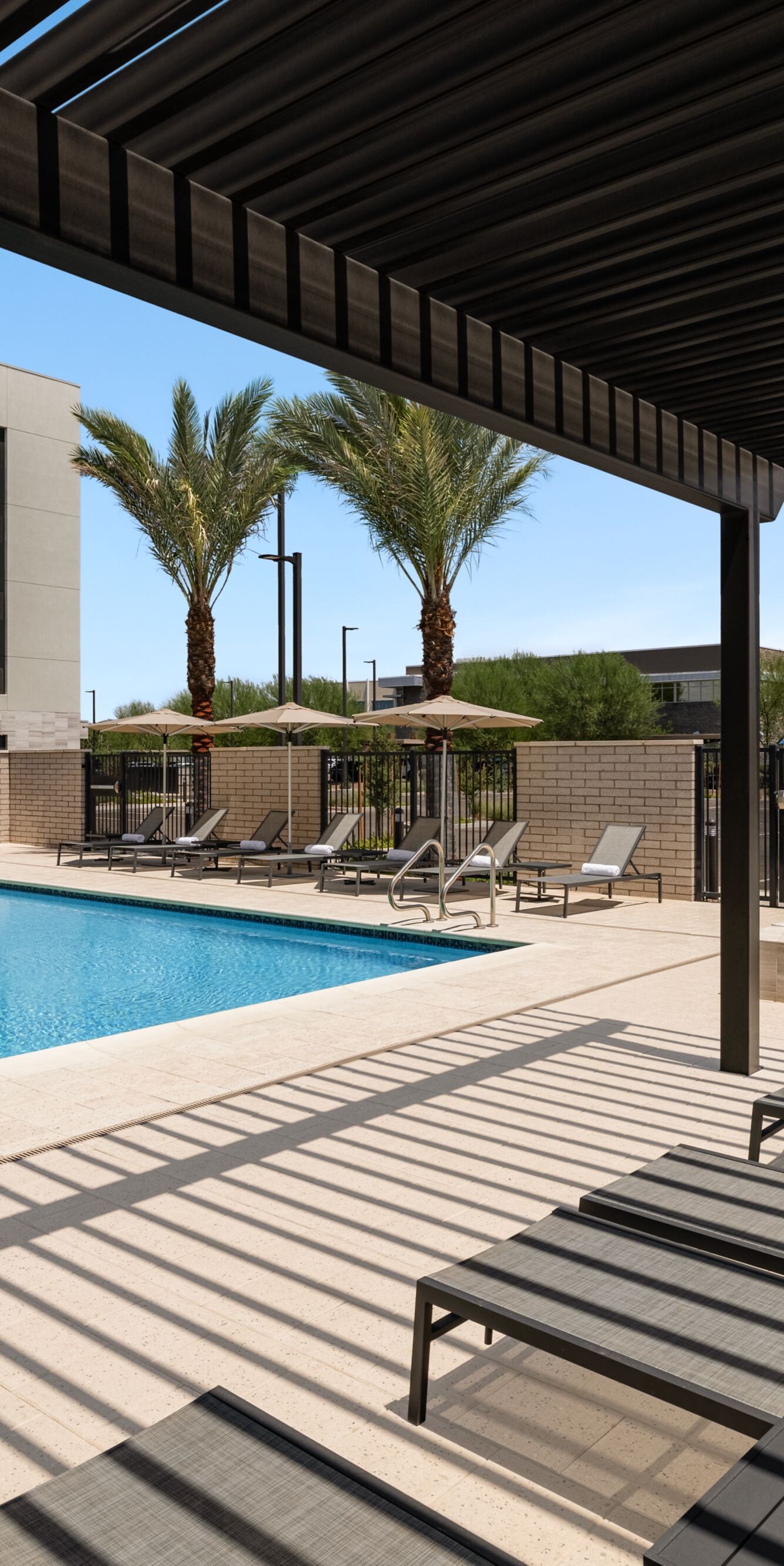 Pool & hot tub with covered lounge chairs