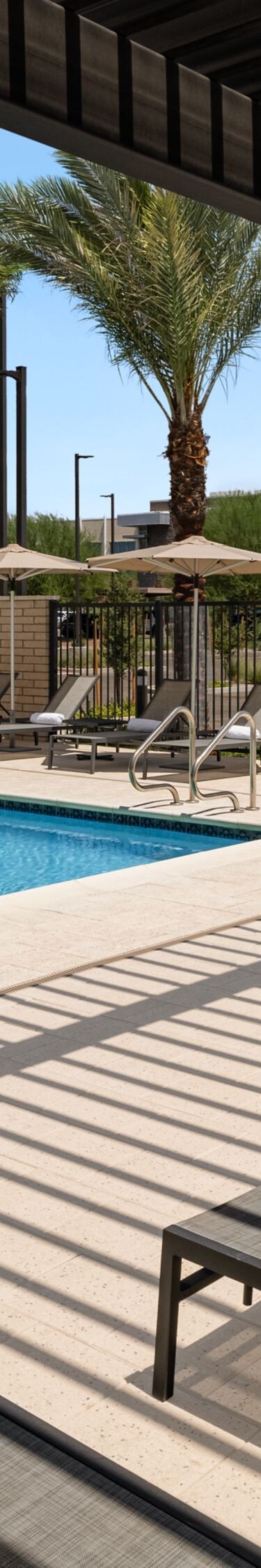 Pool & hot tub with covered lounge chairs