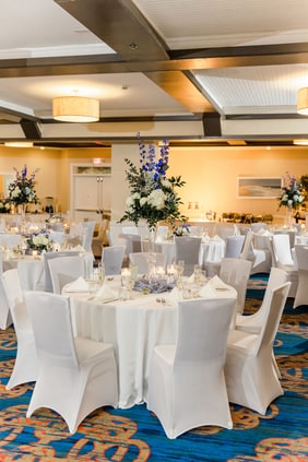 wedding set up in ballroom with tables and chairs
