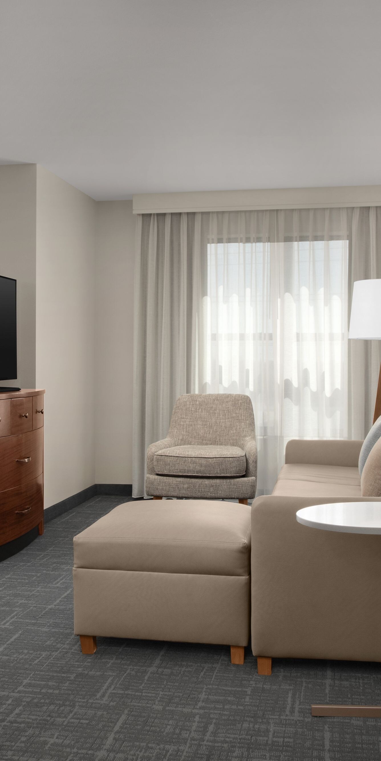 Two-bedroom suite living area with sofa and TV