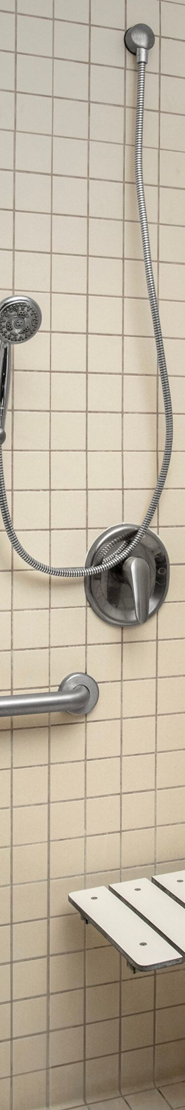 Accessible roll-in shower with grab bars and seat