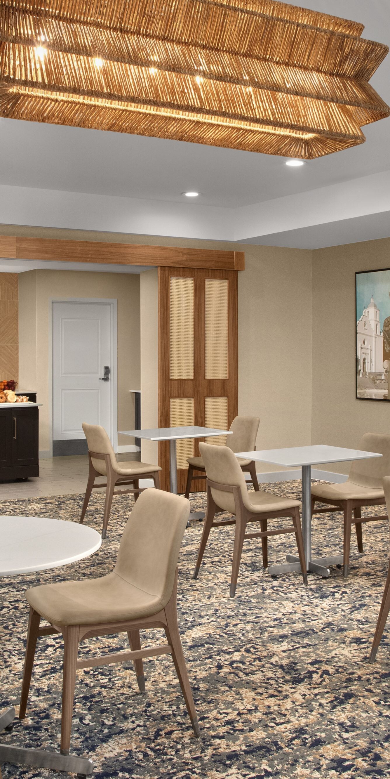 Hotel breakfast seating area with tables and chair