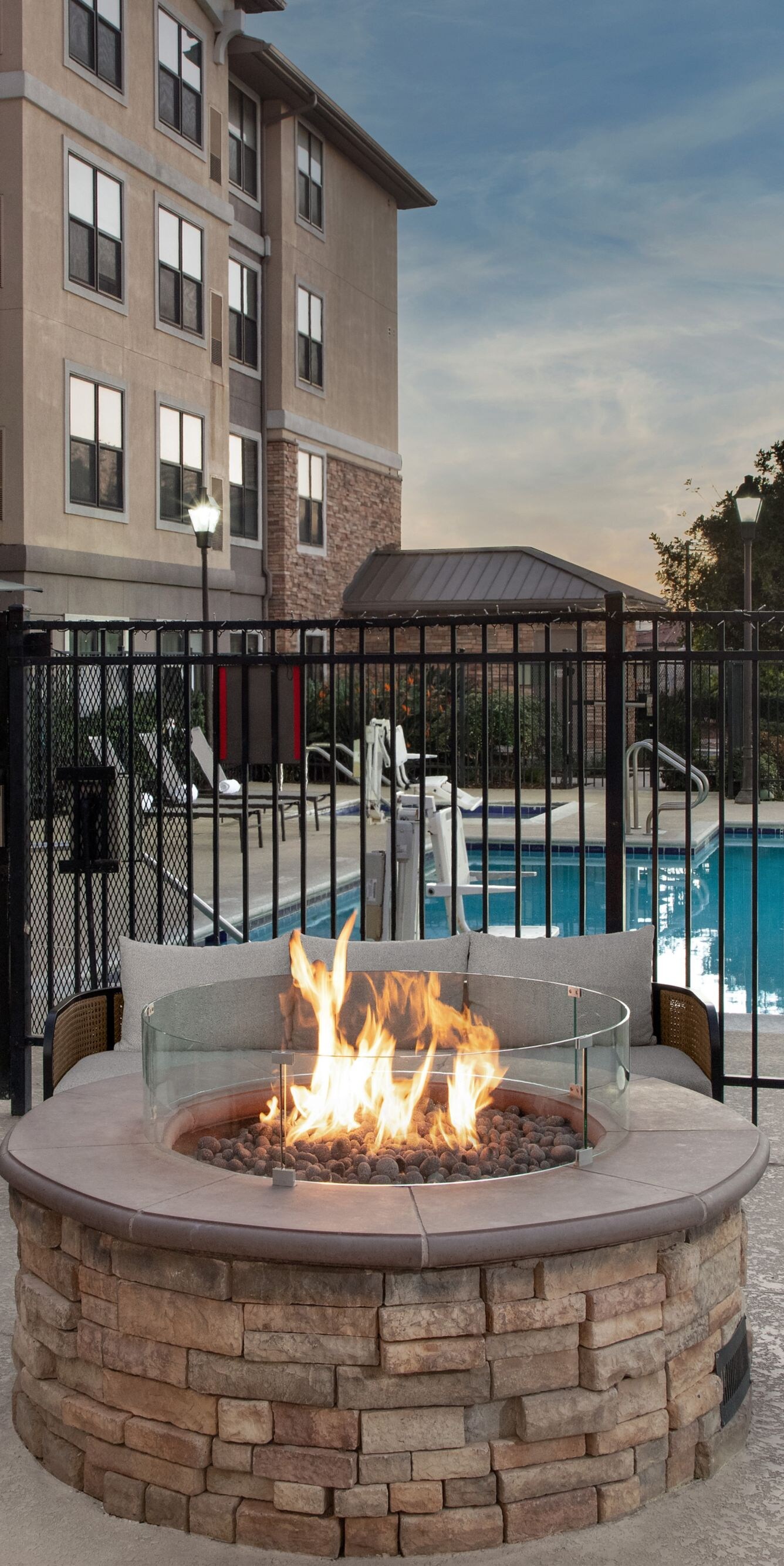 Outdoor hotel fire pit seating near swimming pool