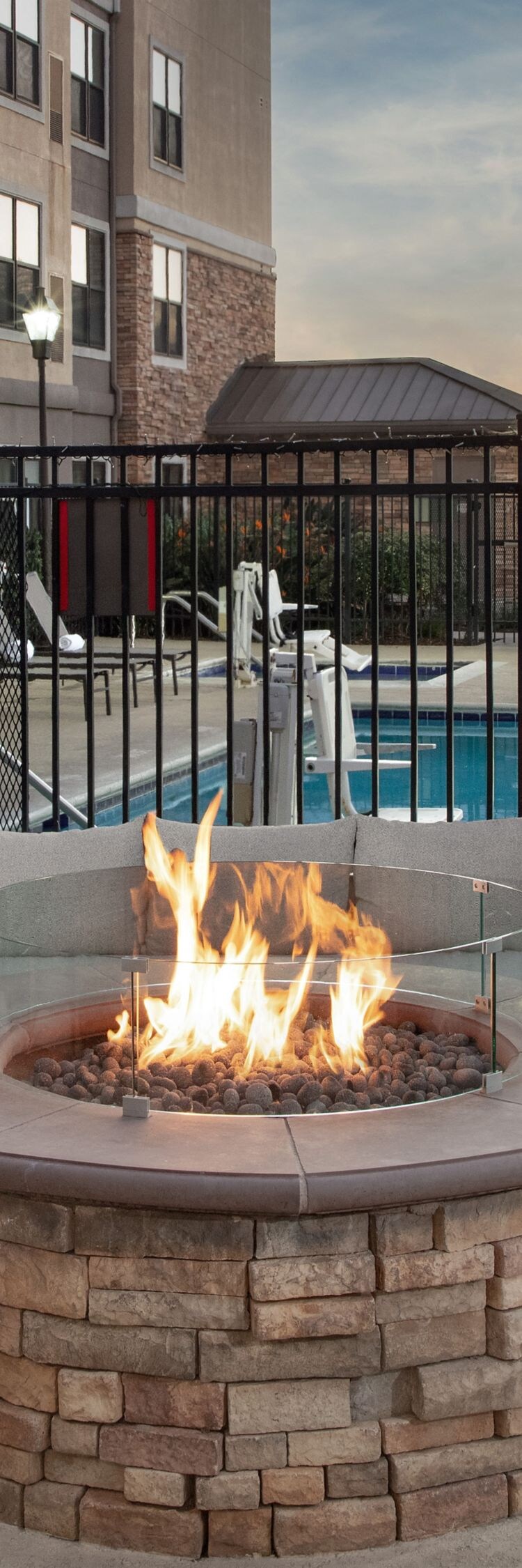 Outdoor hotel fire pit seating near swimming pool