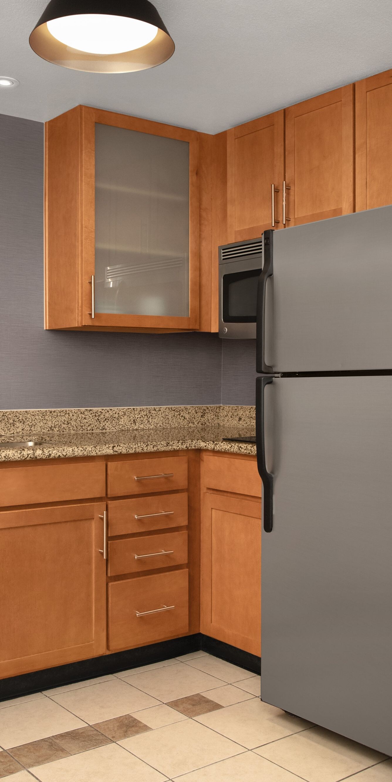 Full kitchen with fridge, dishwasher, and cabinets