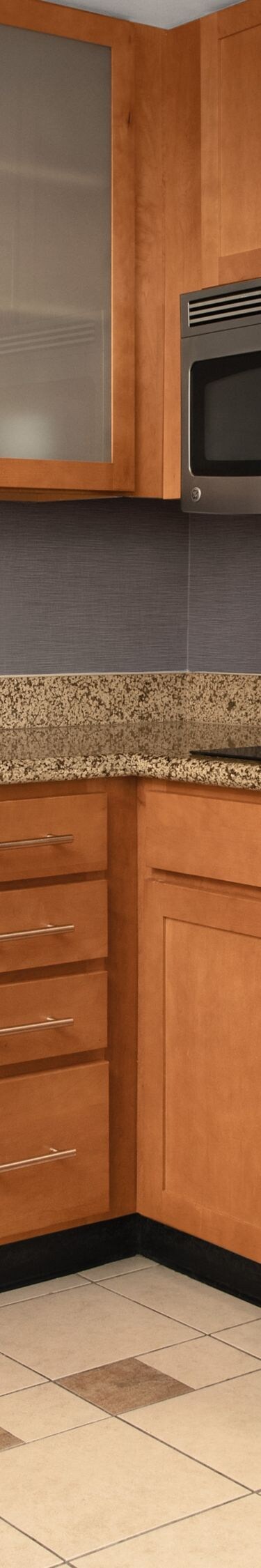 Full kitchen with fridge, dishwasher, and cabinets