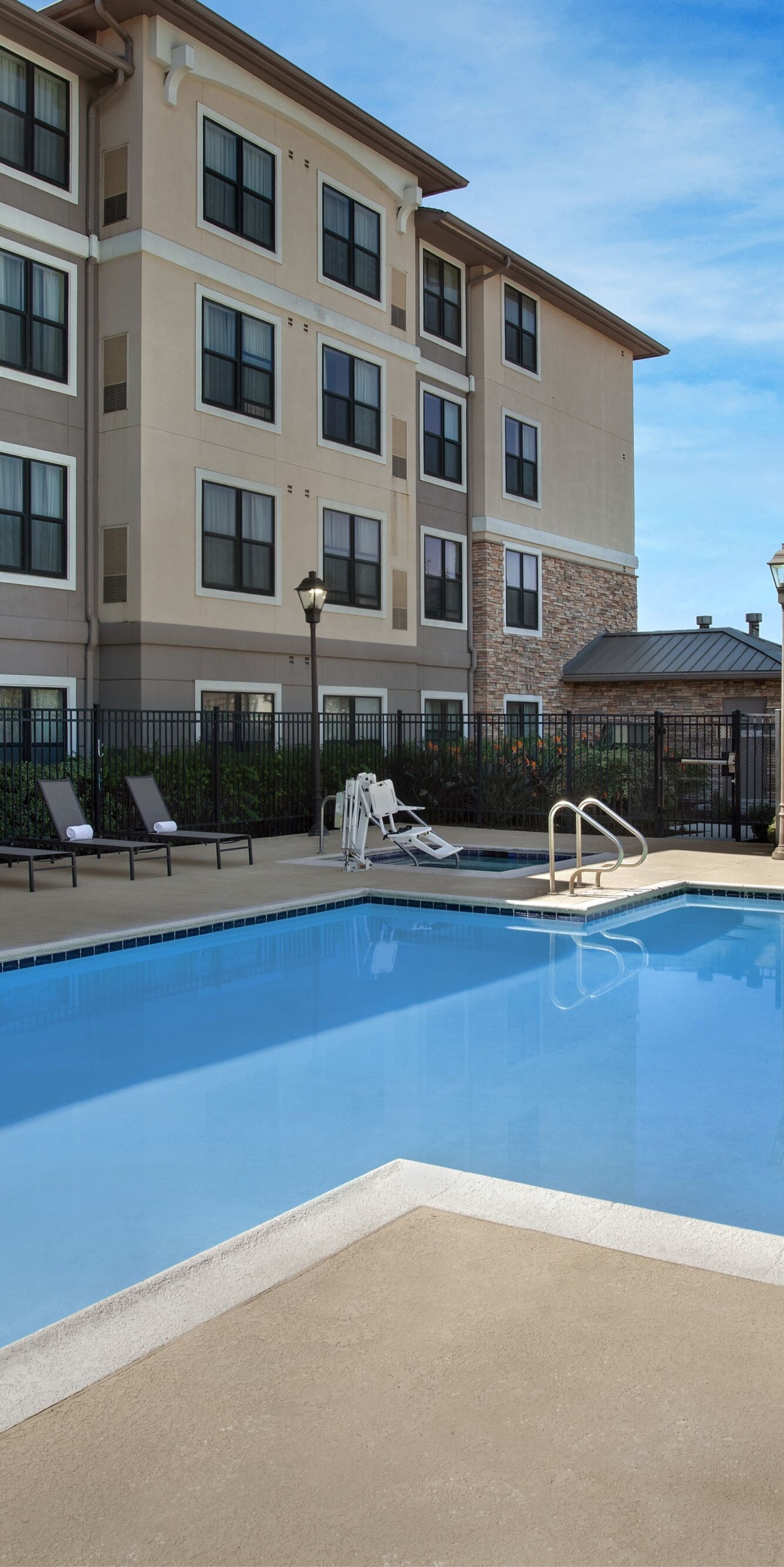 Outdoor hotel swimming pool with lounge chairs