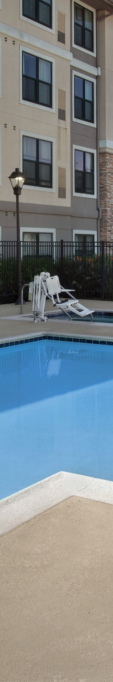 Outdoor hotel swimming pool with lounge chairs