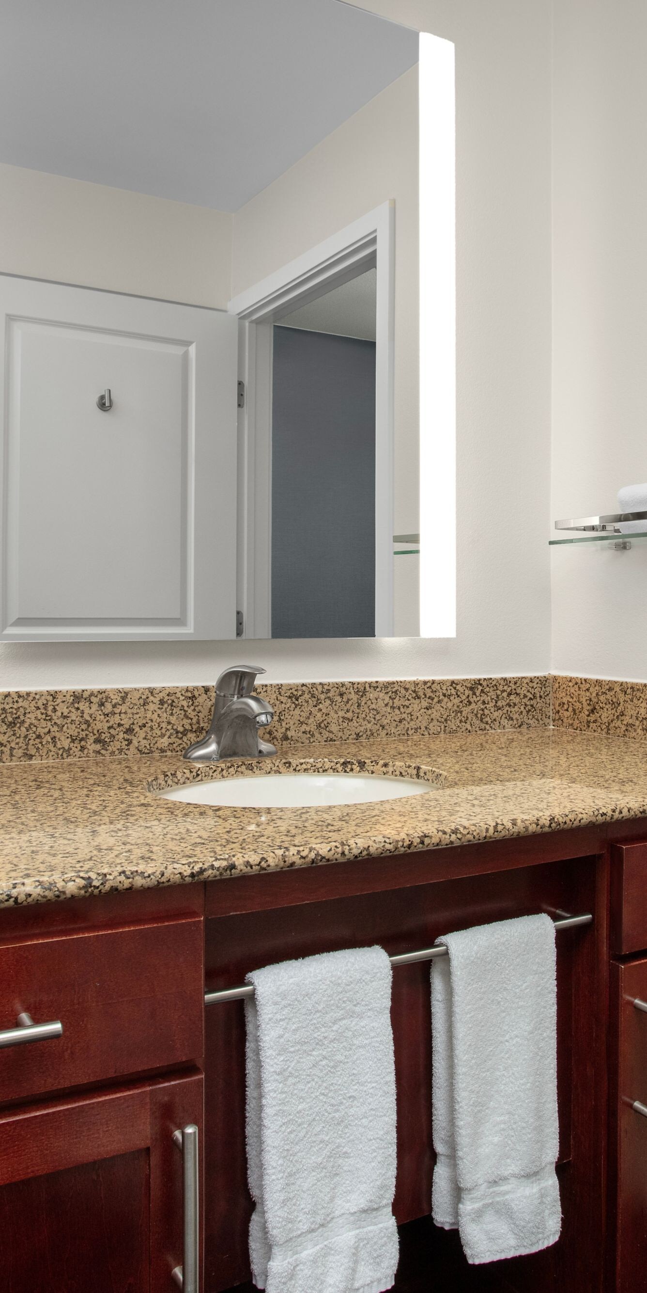 Guest bathroom vanity with sink and mirror