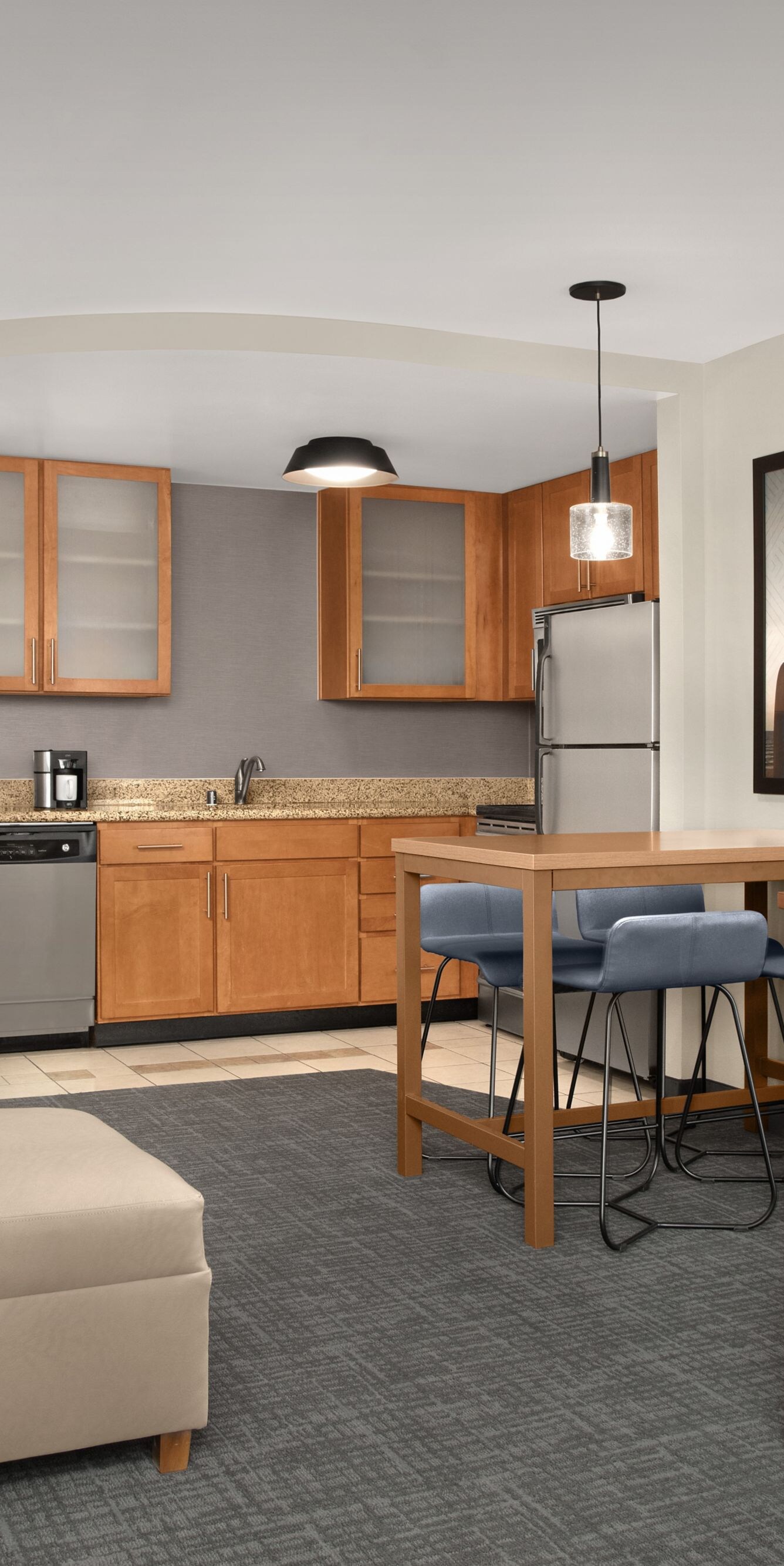 Two-bedroom suite with kitchen, sofa, and TV