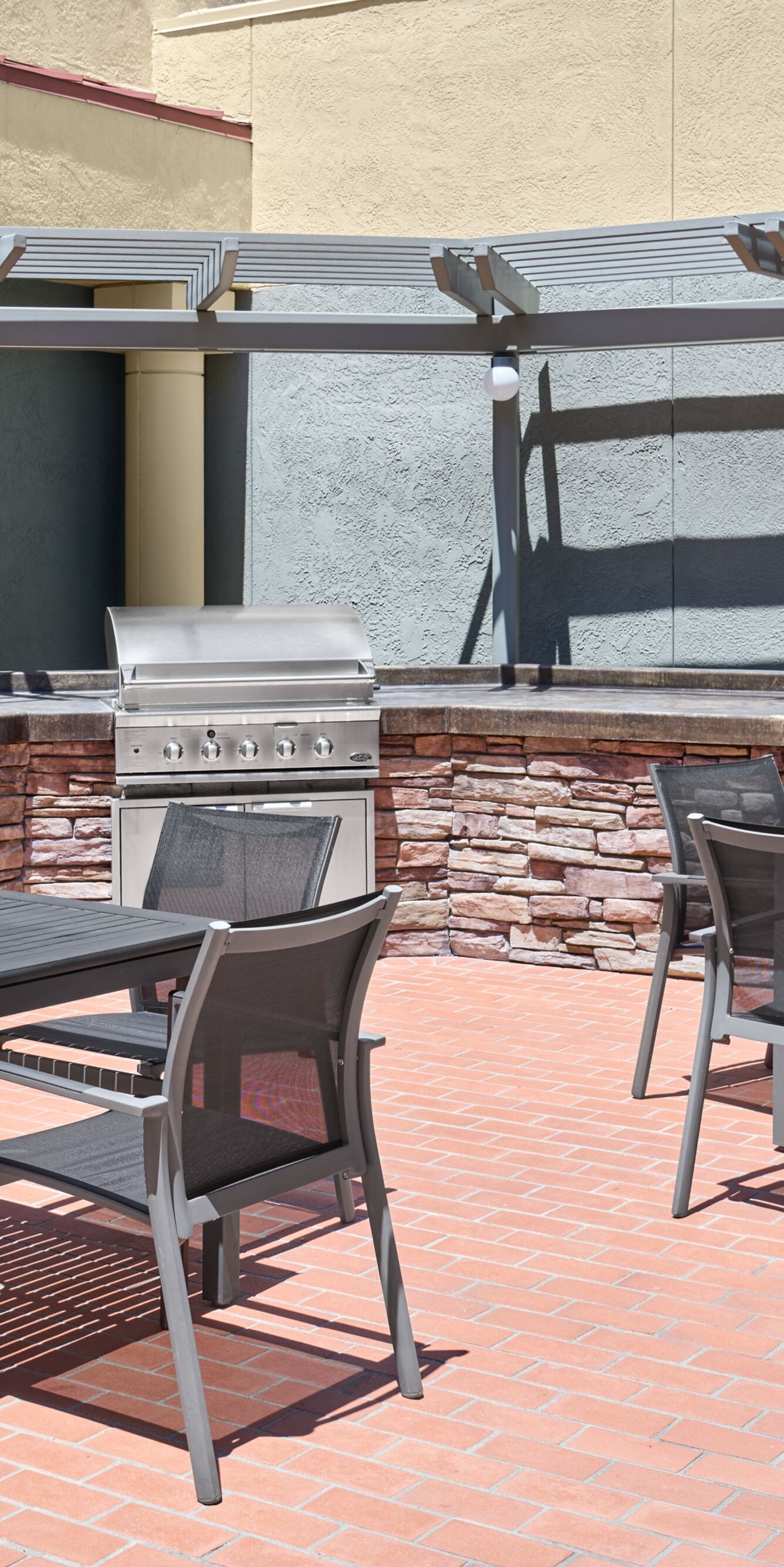 Brick patio with bbq grill and seating