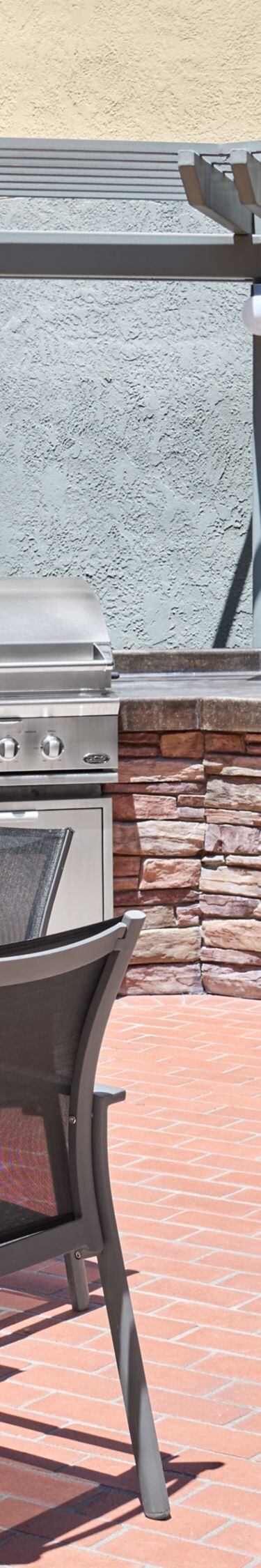 Brick patio with bbq grill and seating