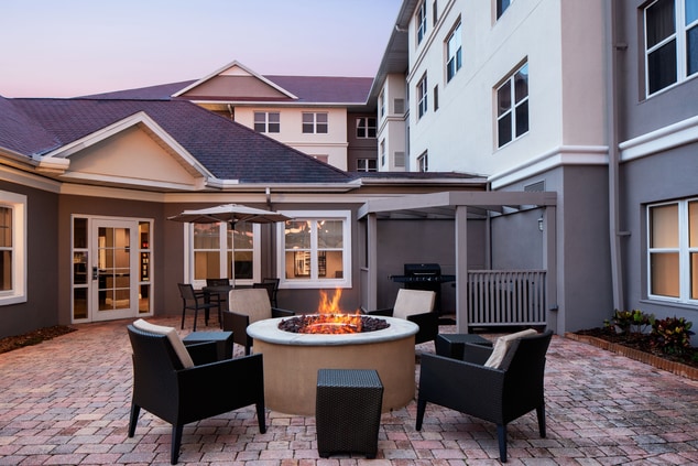 Patio with firepit and chairs around it