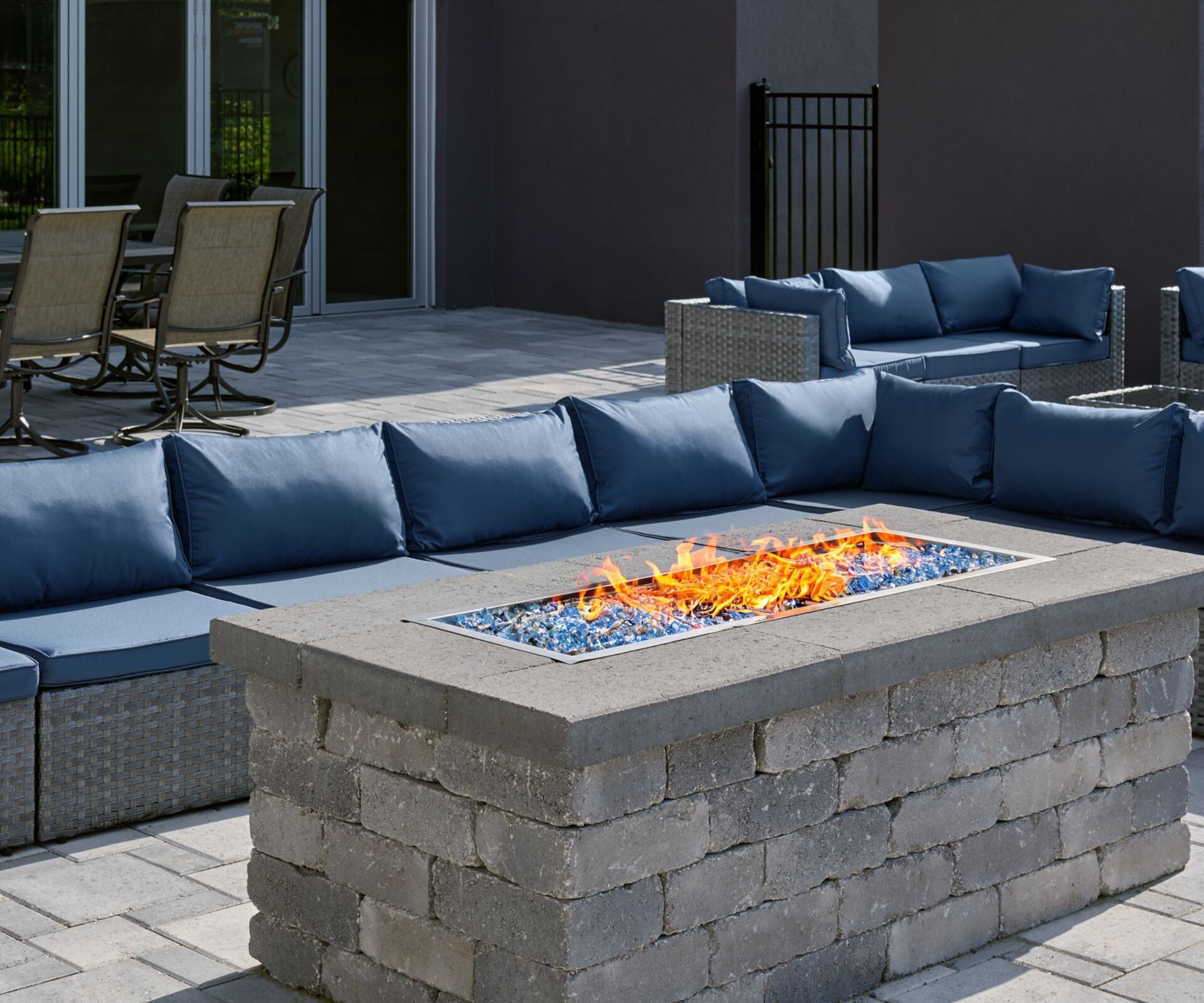 Outdoor patio with fire pit and blue sofas