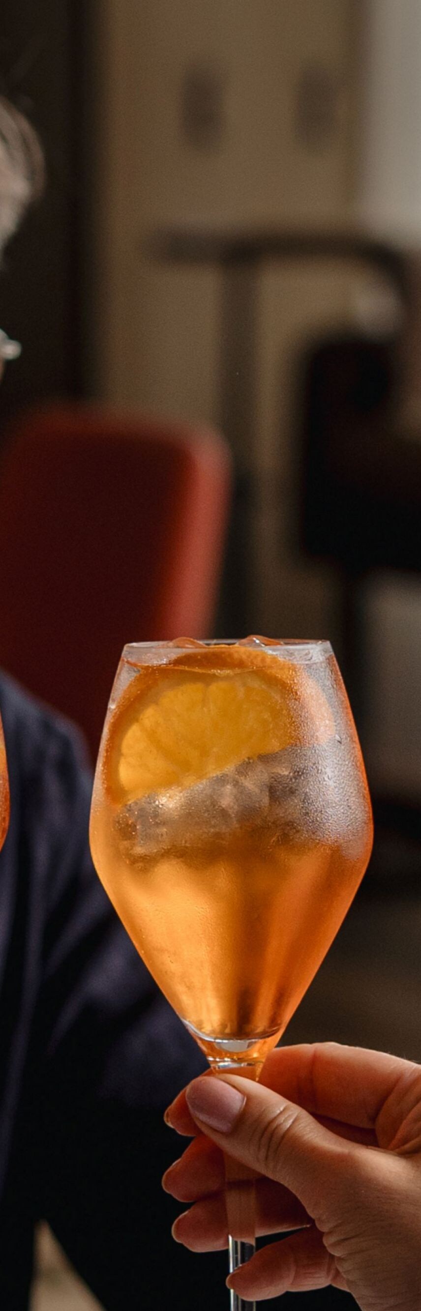 Guests toasting orange cocktails