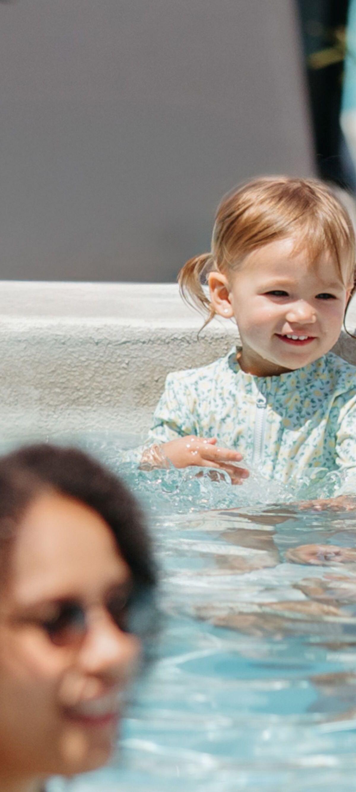 Family spending time poolside