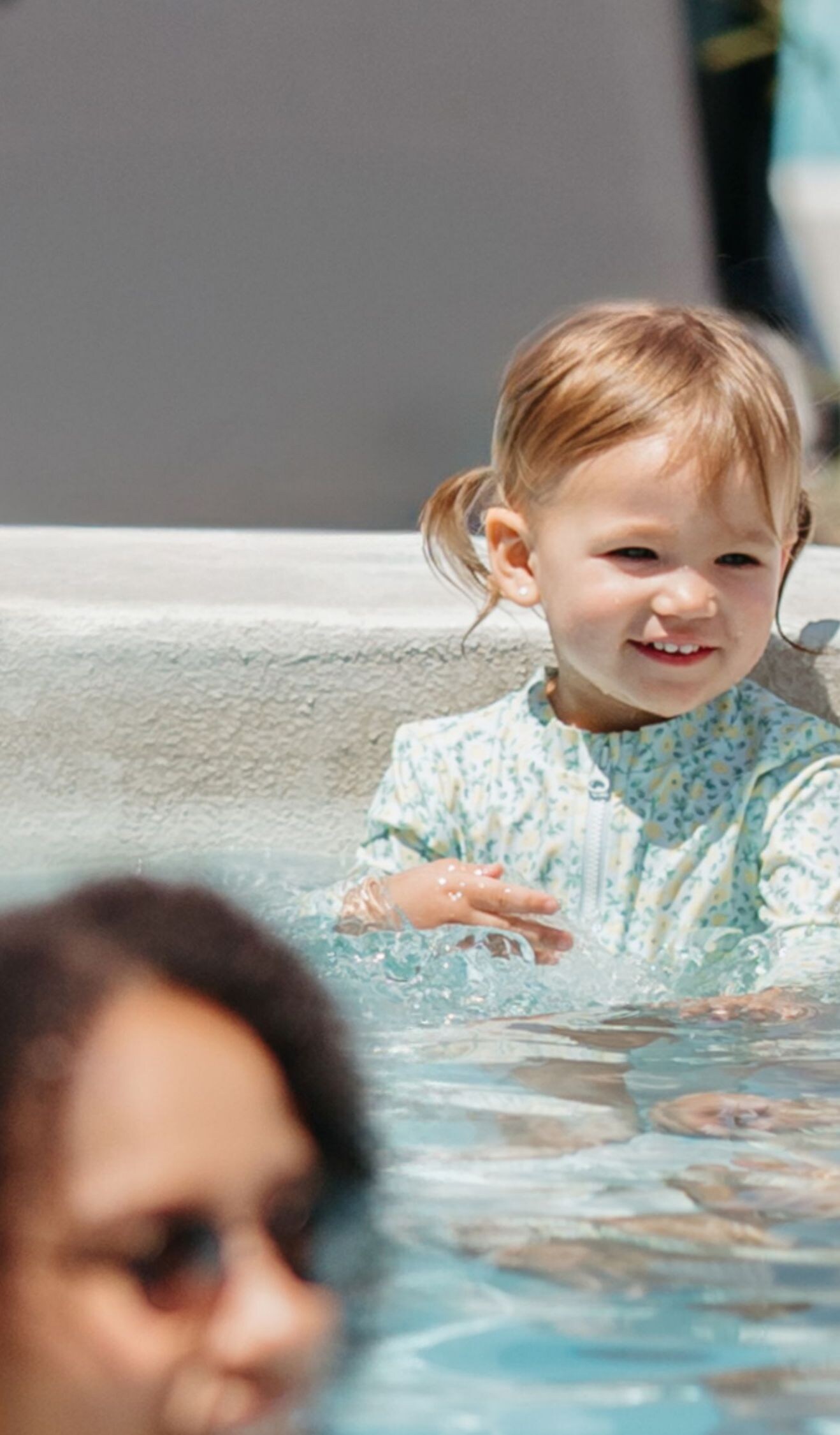 Family spending time poolside