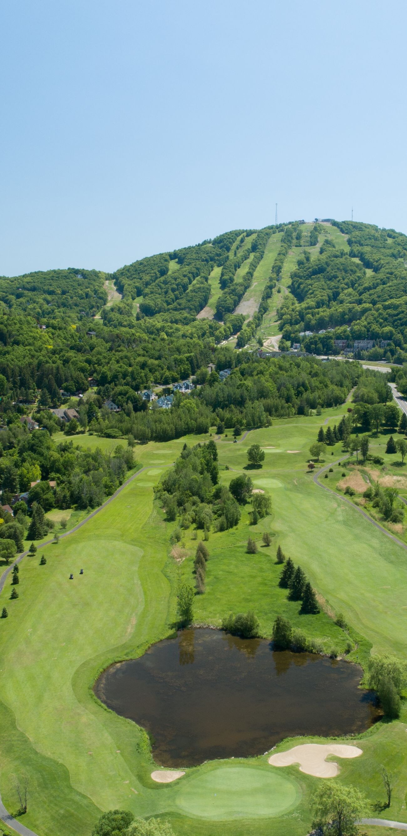 Aerial view of a golf course with rolling fairways