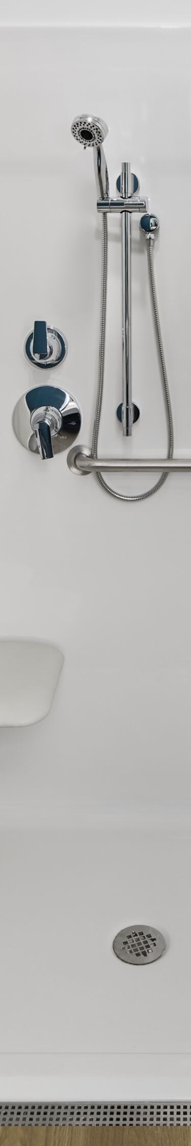 Accessible roll-in shower with grab bars and seat