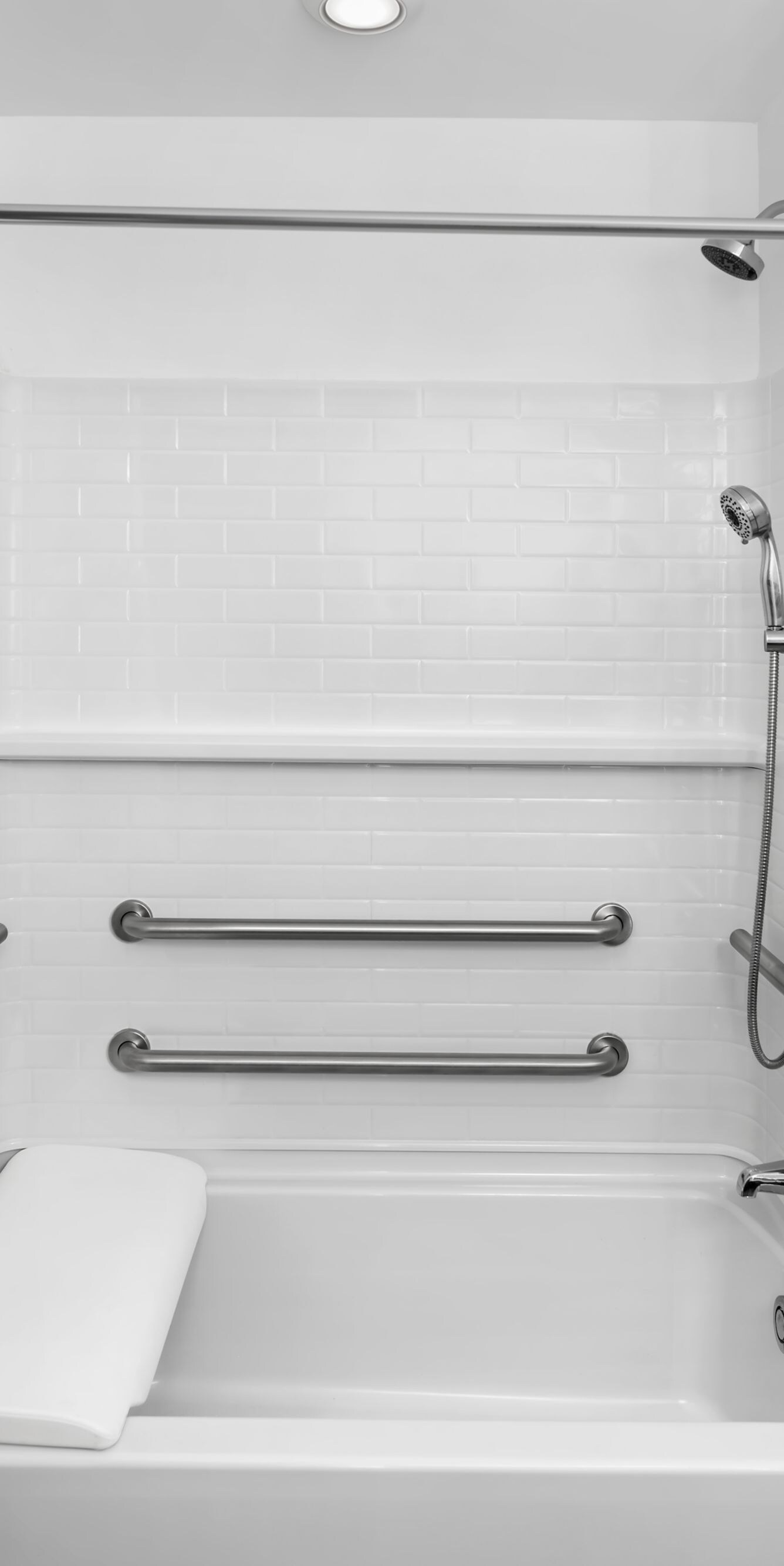 Accessible tub with grab bars and hand shower