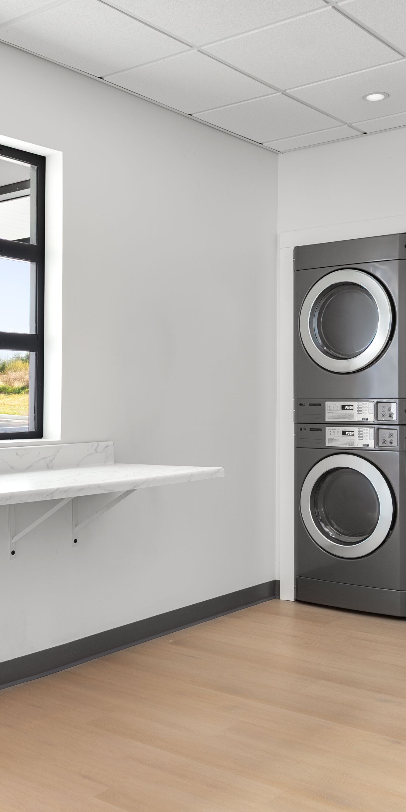 Shared laundry room with washers and dryers