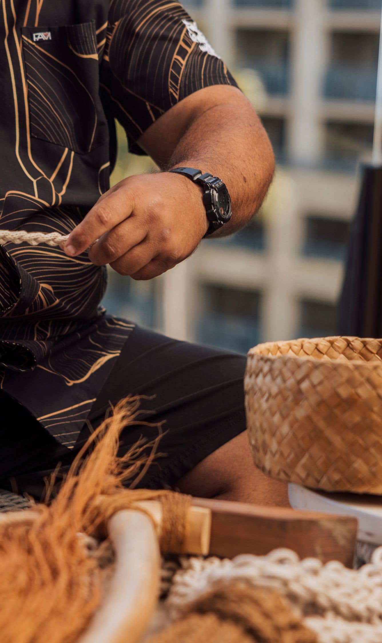 Man sitting and braiding rope