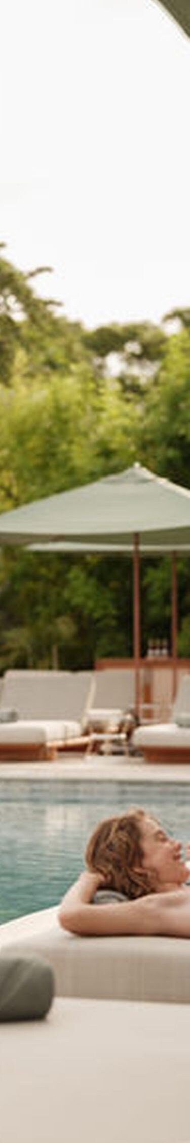 Family relaxing together on cushioned loungers bes