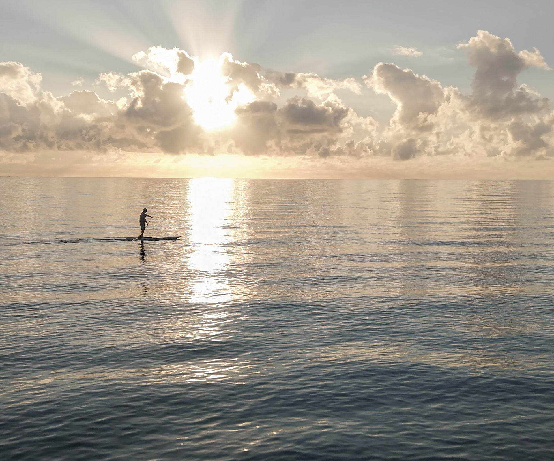 Sunrise reflecting across calm ocean waters
