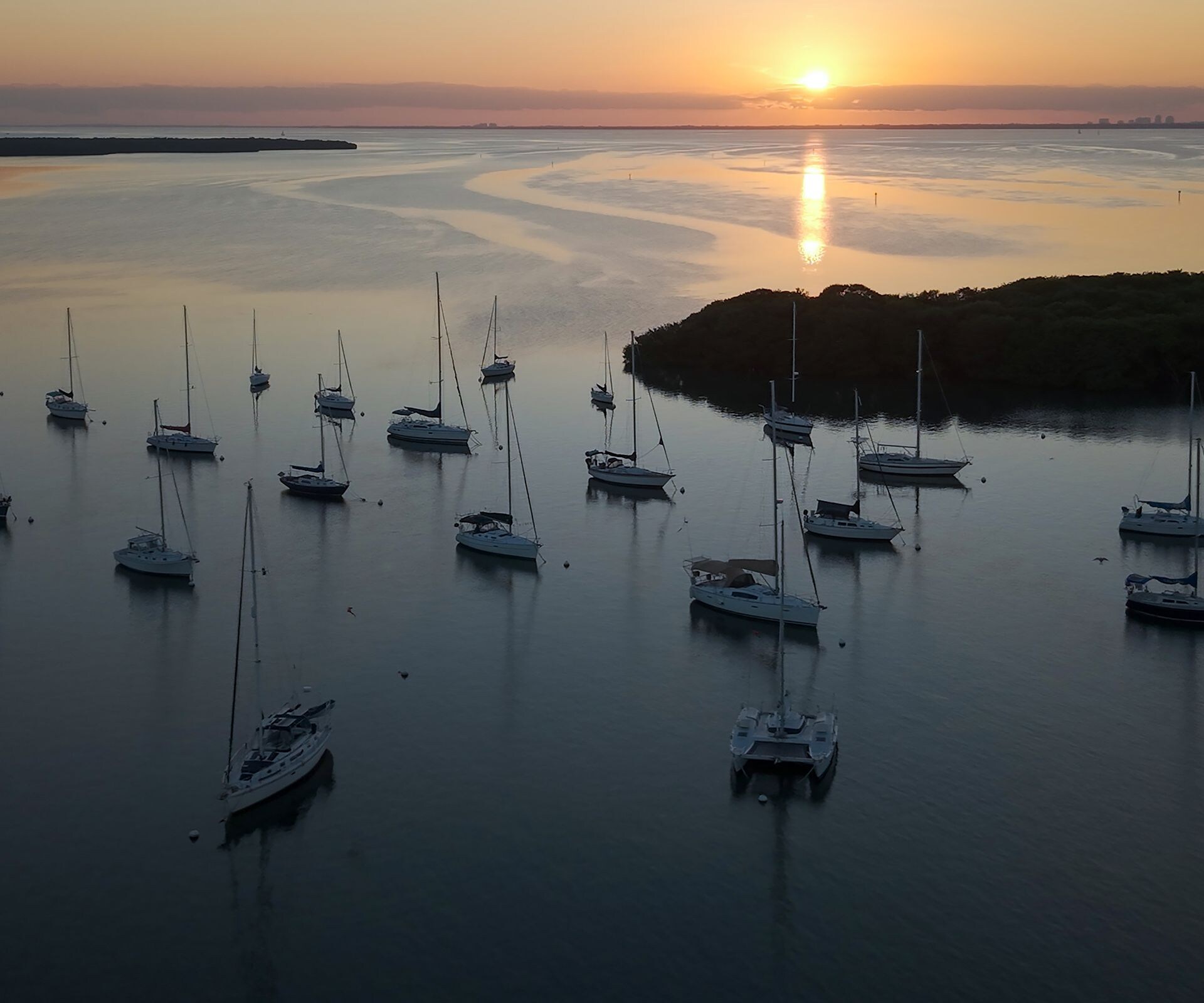 Aerial view of boats at sunset over water