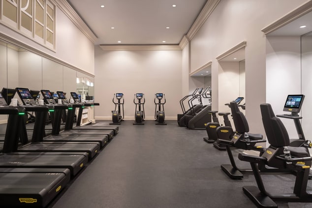 A fitness center with treadmills, stair climbers a