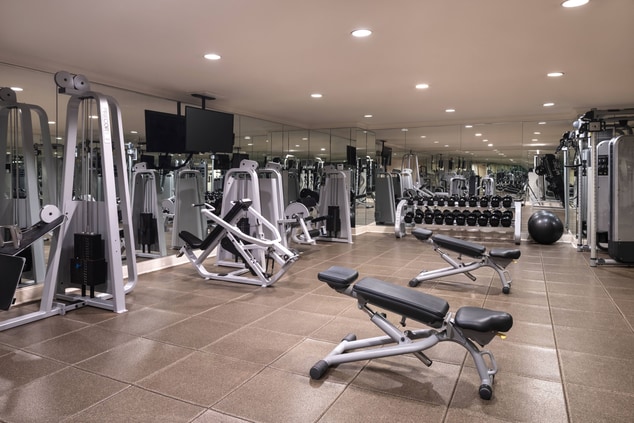 A fitness center with free weights and machine wei