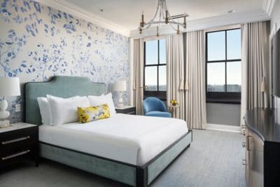 bedroom with king bed, floral wall paper, views