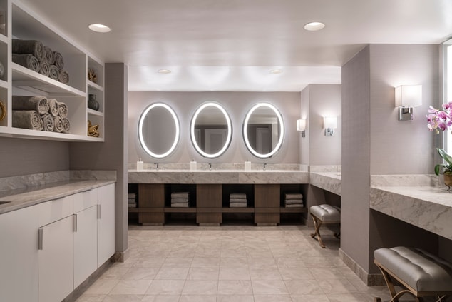 Vanity counter in spa with three sinks and mirrors