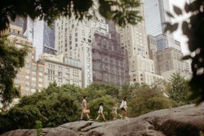 Picture of family of four walking with skyscrapers