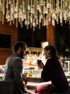 a couple shares drinks at the bar