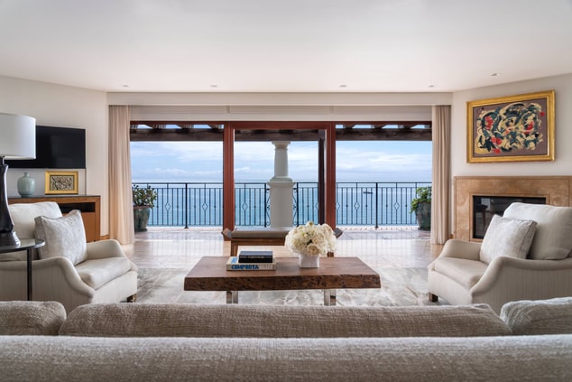 Suite with floor to ceiling windows and ocean view