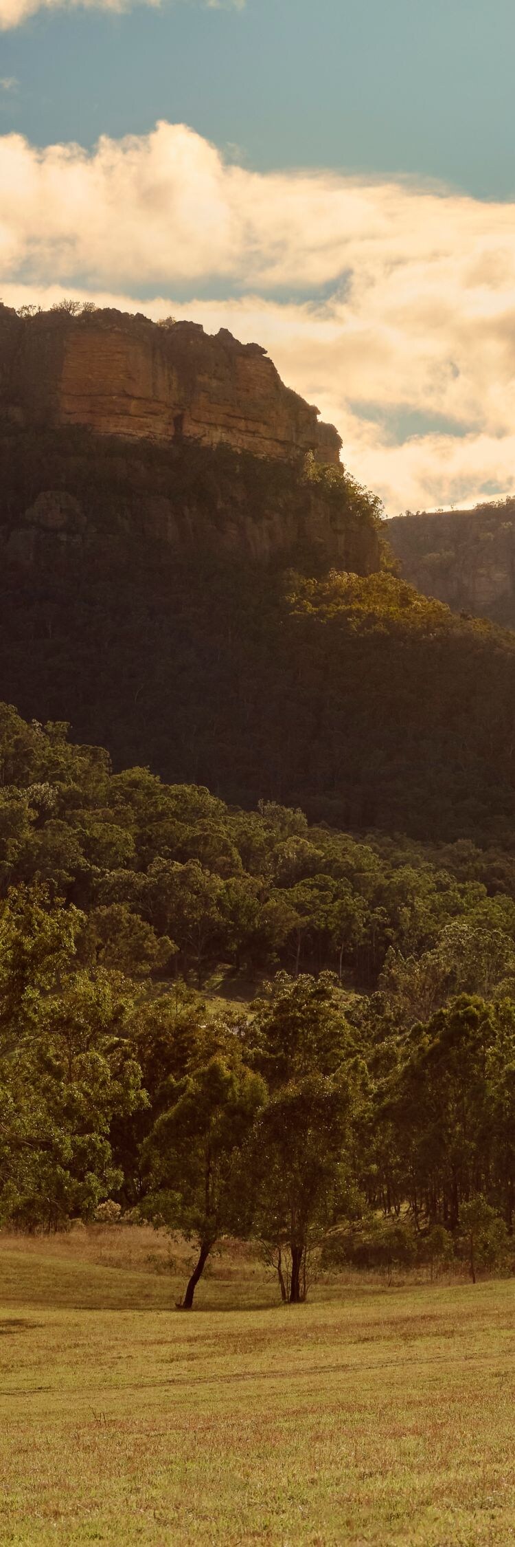 Riders beneath sandstone escarpments