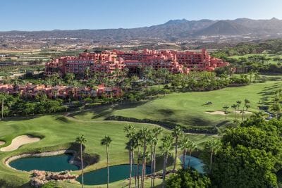 Golf course with resort and ocean views