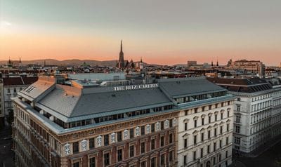 A Vienna hotel roof against the skyline at sunset