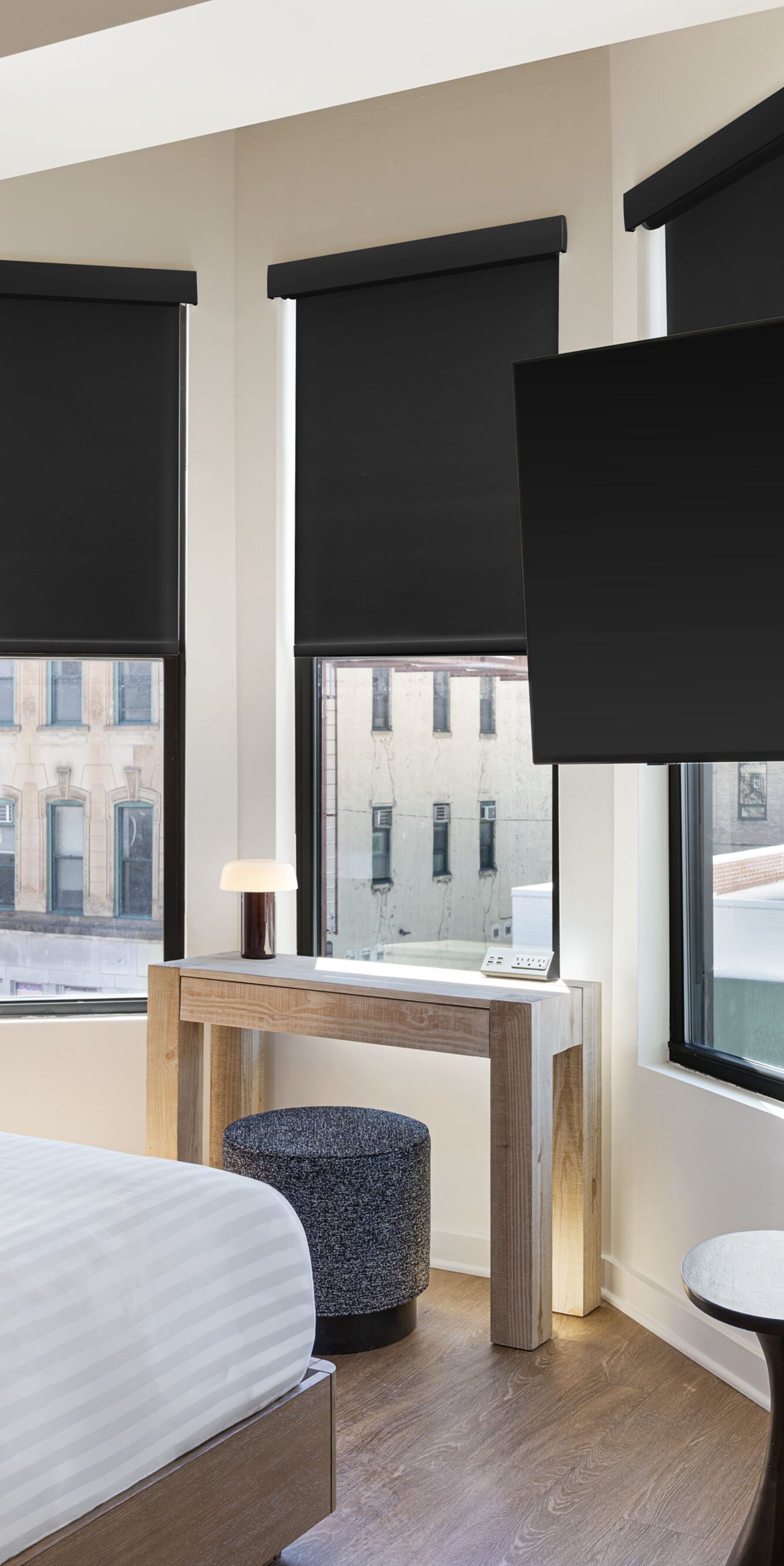 bed, armchair, tv, multiple windows