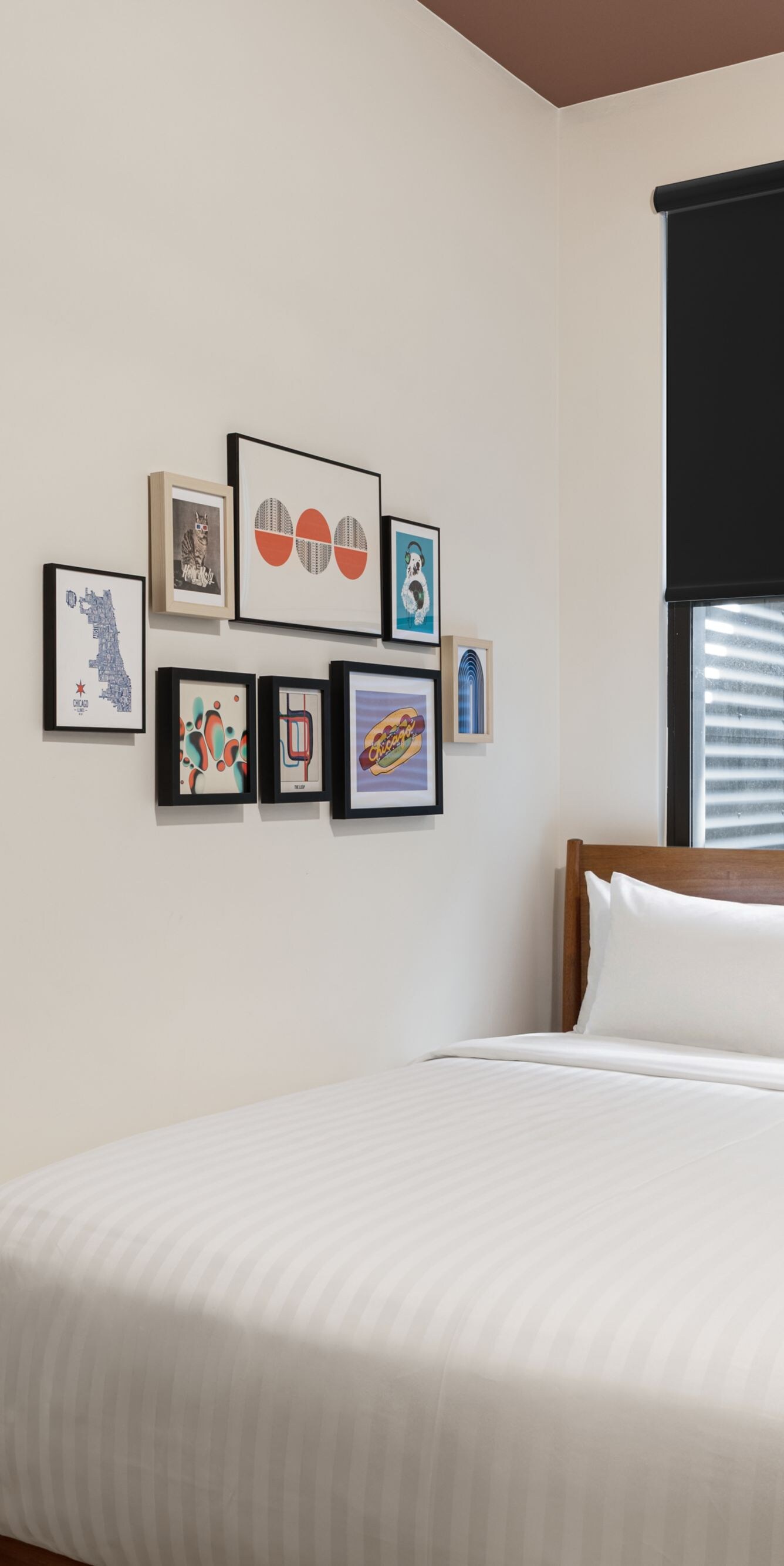 bed, wall mirror, and artwork