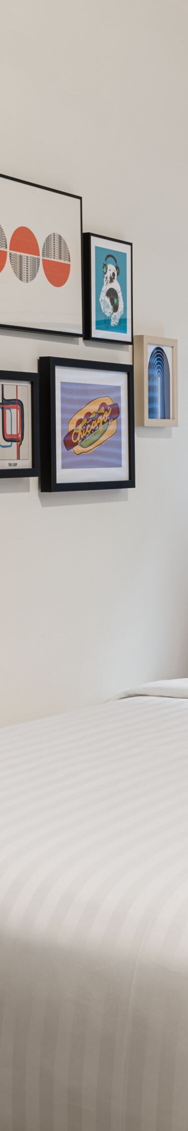 bed, wall mirror, and artwork