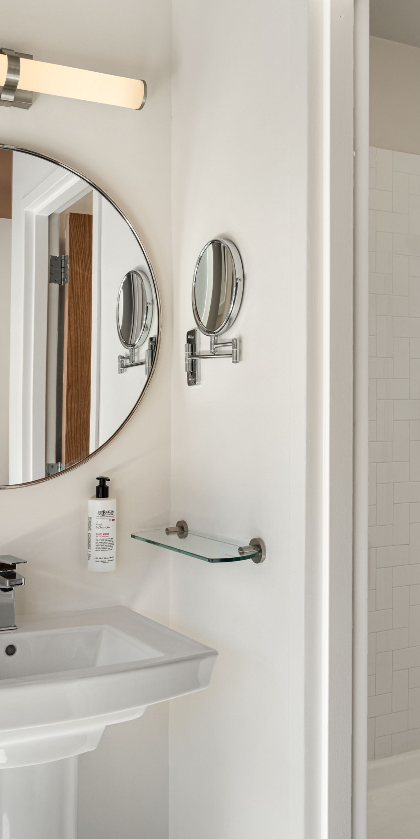 vanity, round mirror, walk-in shower