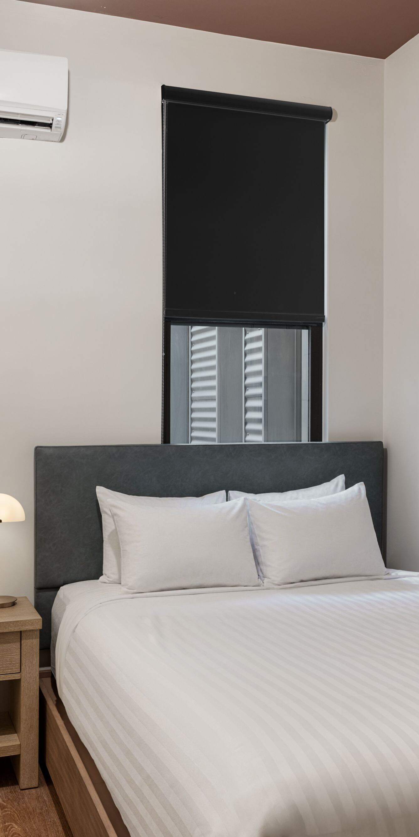 Queen guest room with bedside table and artwork