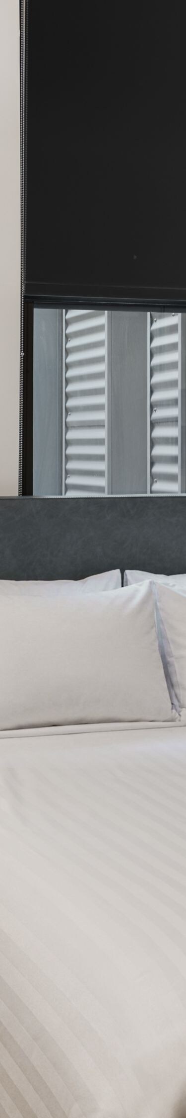 Queen guest room with bedside table and artwork
