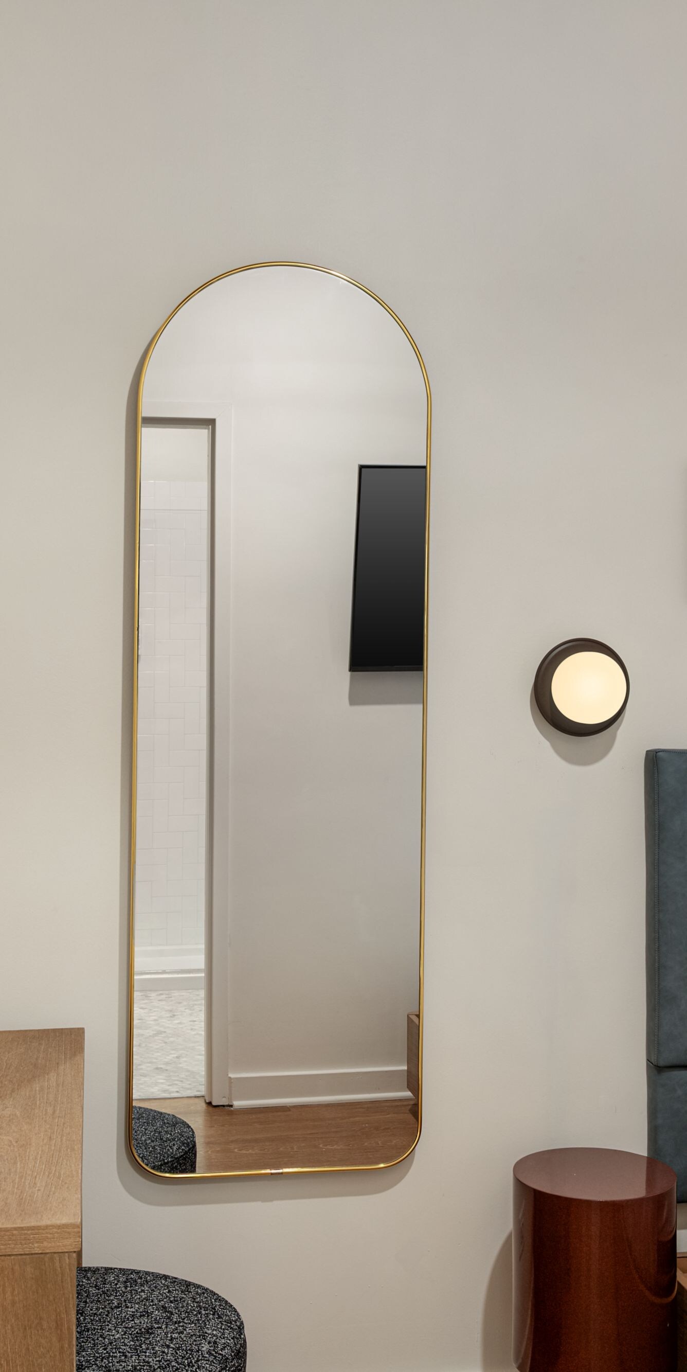 Queen guest room with bed, mirror and artwork